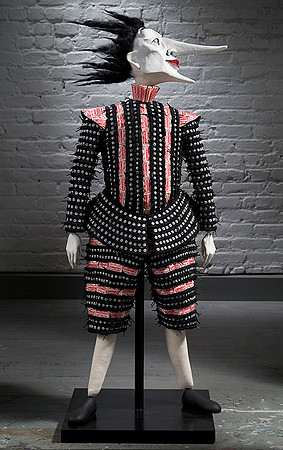 Mr. Black, Four foot puppet with long nose looking to the right in costume made from shoe laces
