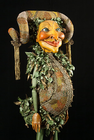 The Cabbage Eater. Yellow faced puppet with rams horn headdress along with costume adorned with tiny glass beads