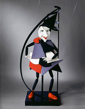 The Geometry Professor, puppet dressed in red, grey, white and black geometric shapes